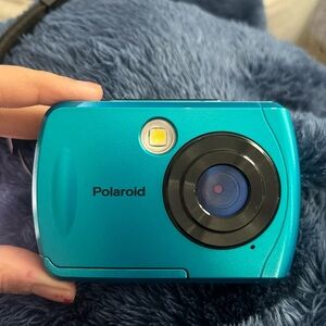 Polaroid blue camera comes with case works fine just need to charger with usb